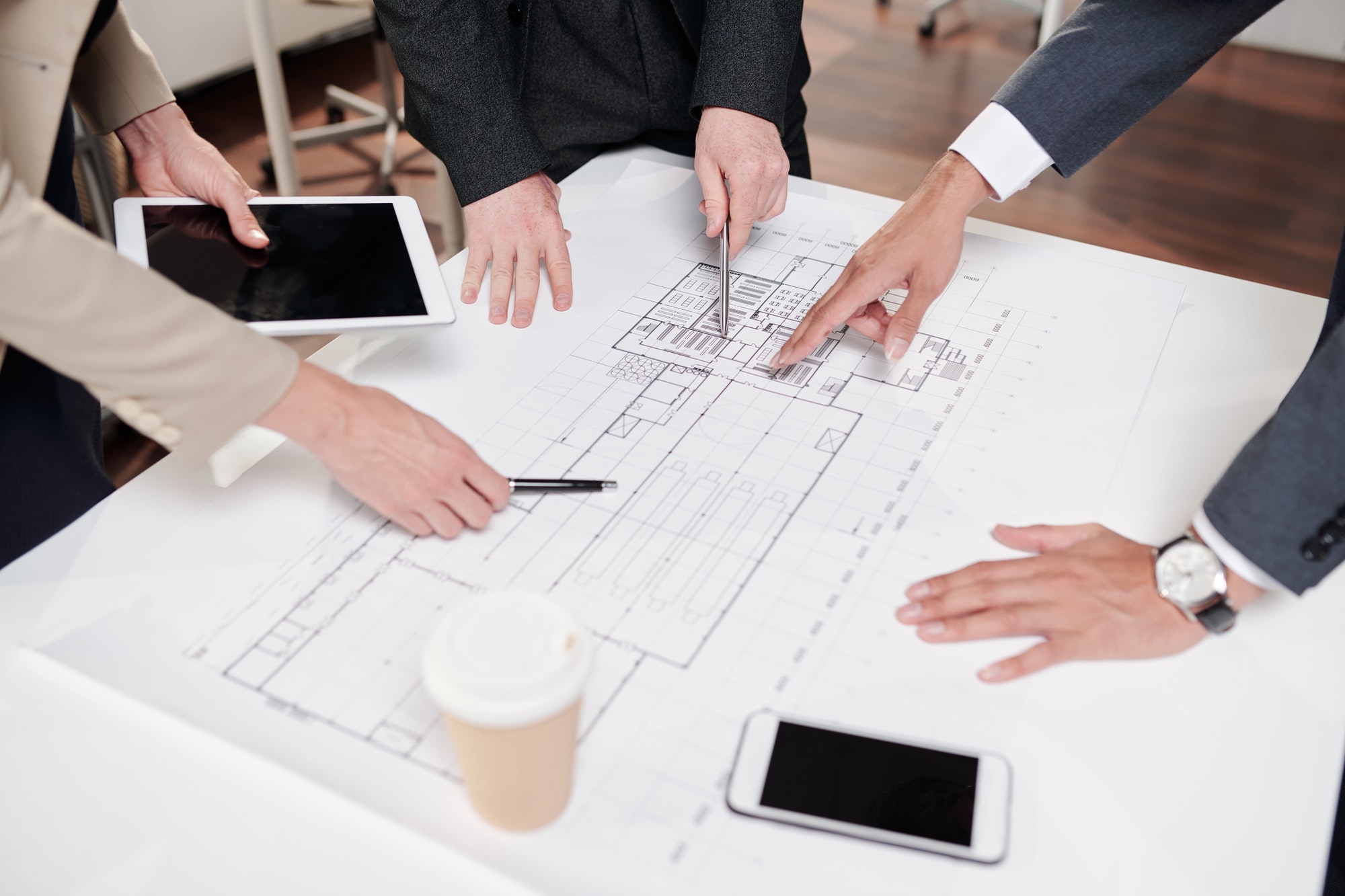team-of-business-people-discussing-construction-plans.jpg